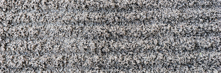 Dark gray fine gravel stones as background or texture