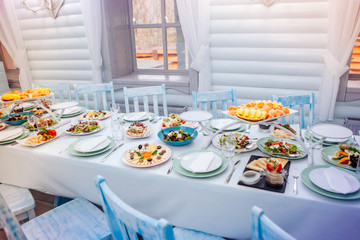 White dining table with restaurant kitchen