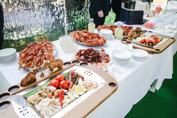 Buffet table with meat and prawns