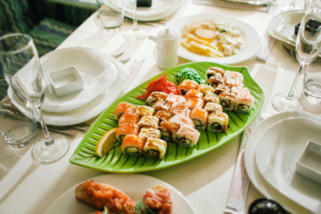 Sushi in a plate on the table. Leaf shaped