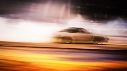 Fototapeta na wymiar car drifting, Sport car wheel drifting and smoking on blurred background. Motorsport concept.