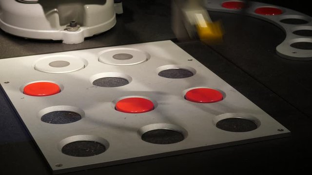 Articulated robotic arm remove red plates from tic-tac-toe playing board, game finished, computer prepare place for new round. Interactive exhibition at science exposition for children