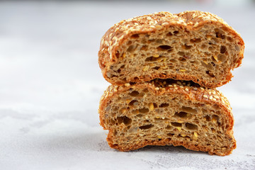 Protein bread (without flour) with linseeds, sunflower seeds and sesame seeds in wooden bowl. Selective focus. Natural light.