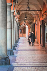 Elderly couple on an empty street of Bologna, Italy © abrilla