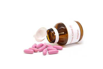 Vaccines (Covid-19) Antivirus Corona virus. Prescription pill bottle spilling pills on to surface isolated on a white background. 