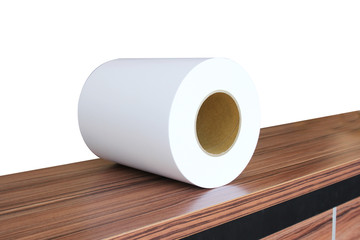 White photo paper rolled on a brown wooden table