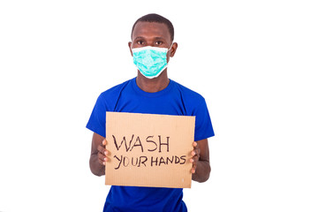 portrait of a young man with medical mask holding a poster