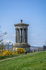 Naklejka premium View of Dugald Stewart Monument with vegetation around and a path , in Edinburgh
