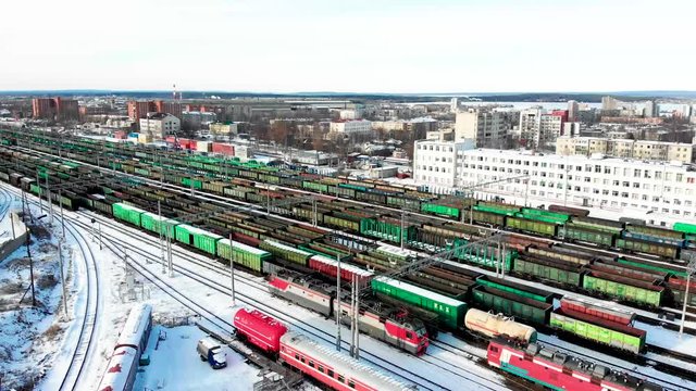 Railway station from the air with a large number of freight trains flying near the station