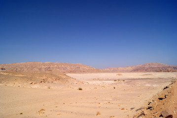 Fototapeta na wymiar Beautiful panorama of the Sinai Desert. Mountains and sands of different shades. Clear blue sky