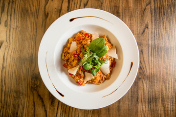 Risotto with vegetables in red sauce