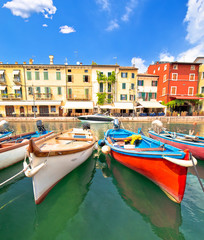 Fototapeta na wymiar Lazise turquoise harbor and waterfront view, Lago di Garda