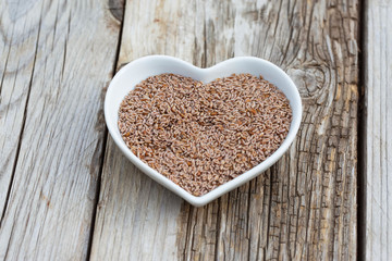 Portion of Psyllium Seeds on rustic wooden background. Natural light. Selective focus.