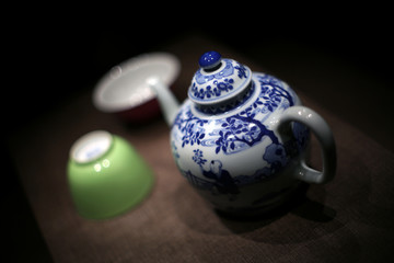 Beautiful Chinese blue and white porcelain teapot with a pink-green tea cup, which is the daily life of the people, starting from drinking a cup of tea