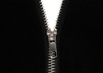 Open zipper or clothes lock on black fabric