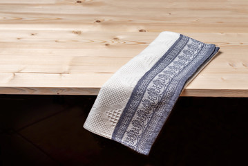 Tablecloth with grey pattern on empty wooden table
