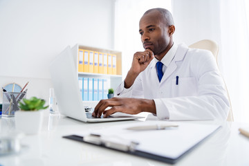 Photo of family doc dark skin guy watch modern technology notebook innovation medical cov viral...