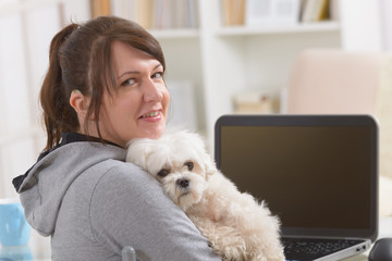 Hearing impaired woman with her dog at home office