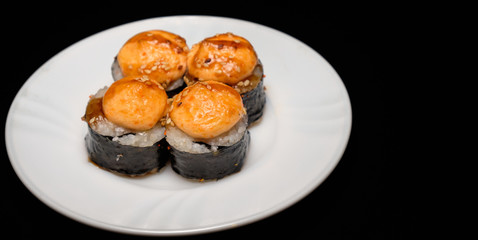 Four baked rolls on a white saucer