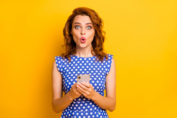 Portrait of her she nice attractive lovely amazed girlish addicted cheerful cheery wavy-haired girl using cell plump pout lips reaction isolated on bright vivid shine vibrant yellow color background