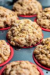 Homemade apple crumble cupcake muffins in tray close up shot side view shallow depth of field