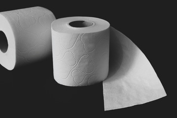 Toilet paper rolls on black background