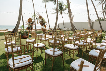 Chairs for wedding ceremony. Wedding ceremony on the beach. Arch; decorated with flowers.