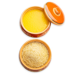 Homemade ghee and rice in a ceramic pot. Isolated white background.