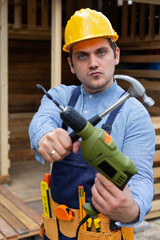 Handsome repairman holding tools