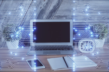 Computer on desktop in office with technology theme hologram. Multi exposure. Tech concept.