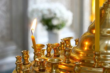  In the Orthodox Church, a lonely small candle burns in a candlestick. Her flame is swinging. The...