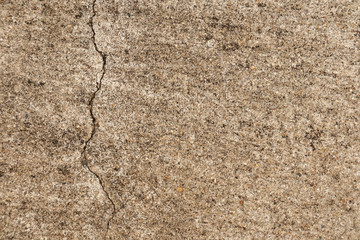A cracks on the concrete floor. Surface of concrete covered with cracks,close up of crack cement road,concrete texture closeup background.