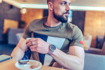 portrait of a good looking man having coffee and waiting