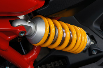 Close up the yellow spring and the rear shock absorbers motorcycle. 