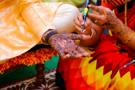 Indian wedding ceremony : groom hand with mehandi design