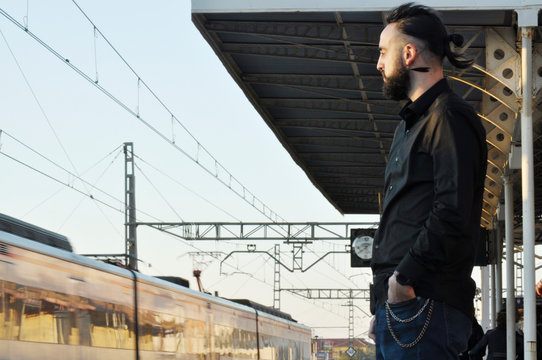 Caucasian Businessman Watching Commuter Train Leaving The Station After Just Missing It