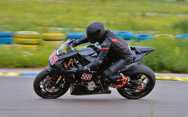 Motorcycle practice leaning into a fast corner on track