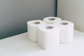 Four toilet paper rolls in isometric style in grey and white colors. Coronavirus infection. Pandemic panic concept.