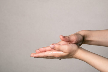 Child cleaning hands with antibacterial alcohol disinfectant