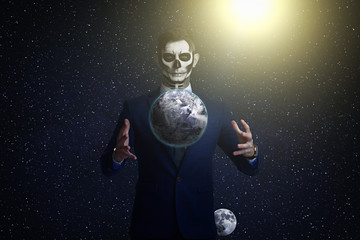 Satan holds the world in his hands. Planet earth in the hands of death. Man With Body Art Skeleton....