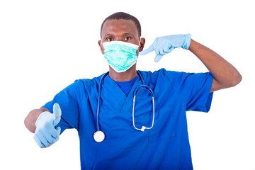 young male doctor pointing finger on medical mask and showing hi