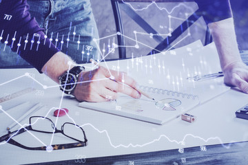 Financial trading chart double exposure with man desktop background.