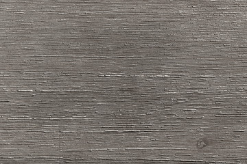 Photographed texture of faded grey brown wood in a horizontal position with grain.