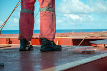 Process of derusting, paint and rust removal by pneumatic chisel from ship deck by vessel crew.