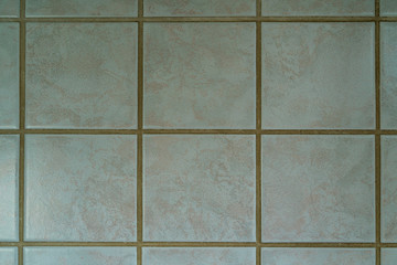 Photographed texture of grey tiles and cement in a square pattern