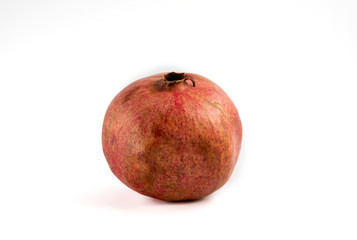 whole organic pomegranate fruit on white background