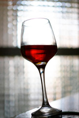 Glass of red wine on white background.