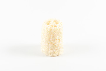 Natural ecological loofah stands upright on a white background.