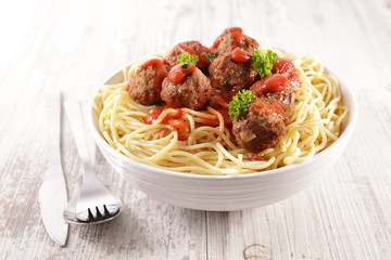 bowl of spaghetti with meatball and tomato sauce