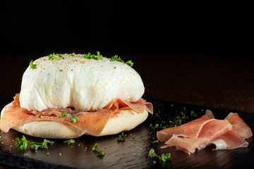 Poached eggs with parma ham and bread